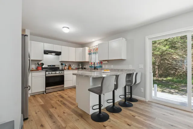 a kitchen with a sink cabinets and wooden floor