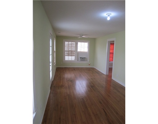 1021 Comanche Street Corpus Christi, TX 78401 - Photo 5 of 5 a view of an empty room with wooden floor and a window