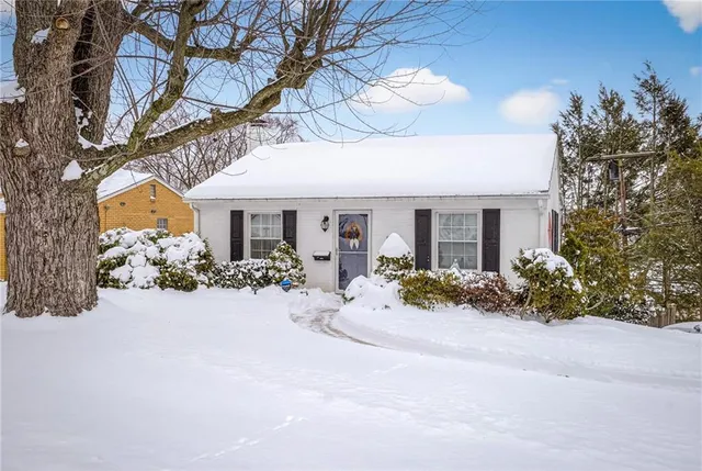 a view of a house with yard and sitting area