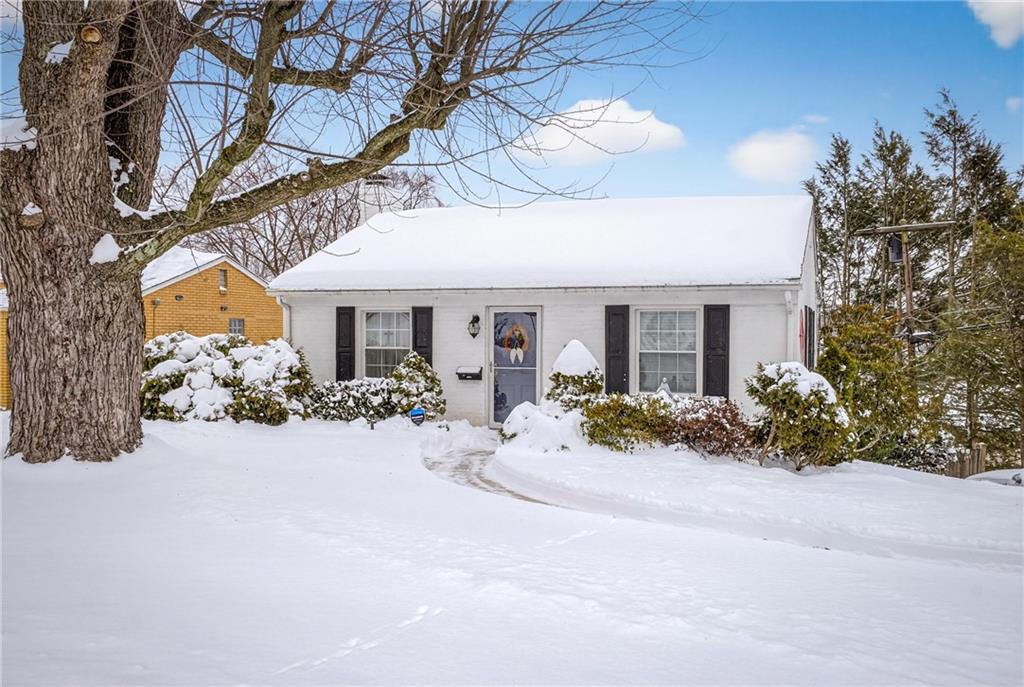 a view of a house with yard and sitting area