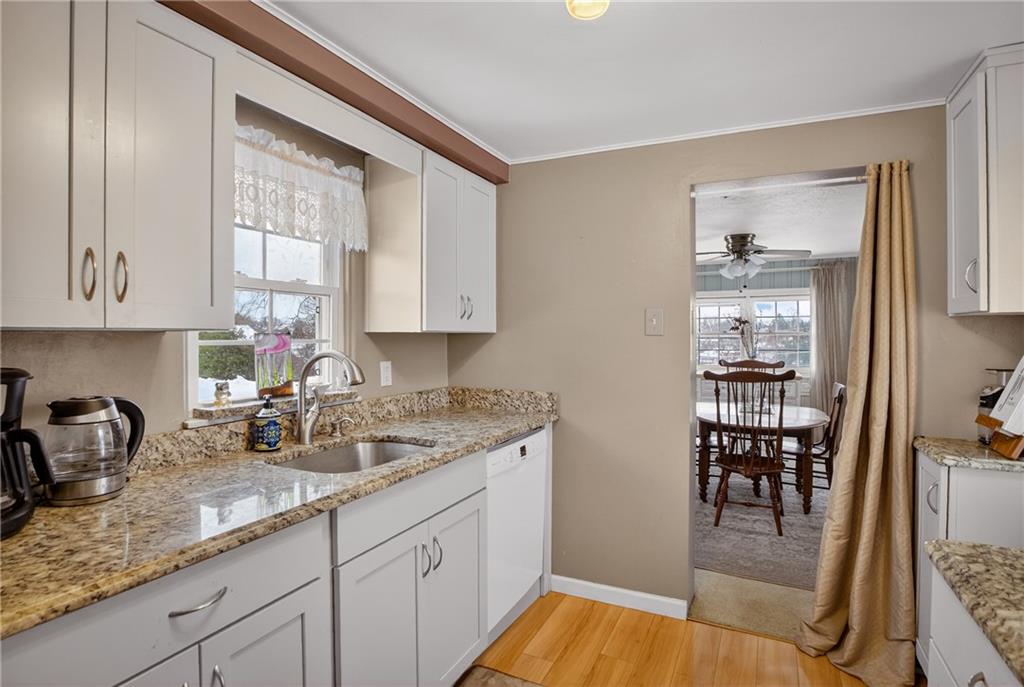 4241 Greenridge Road Pittsburgh, PA 15234 - Photo 13 of 50 a kitchen with sink cabinets and wooden floor