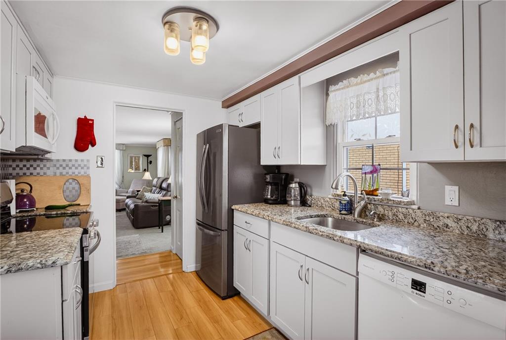 4241 Greenridge Road Pittsburgh, PA 15234 - Photo 15 of 50 a kitchen with refrigerator cabinets and a sink