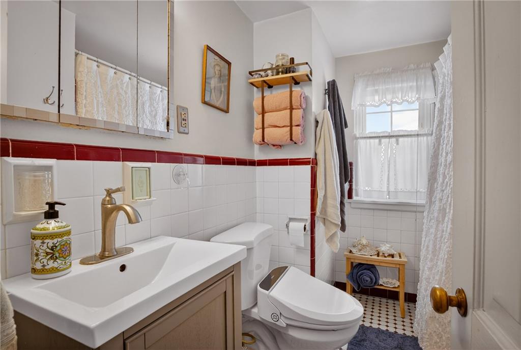 4241 Greenridge Road Pittsburgh, PA 15234 - Photo 25 of 50 a bathroom with a sink a toilet and mirror