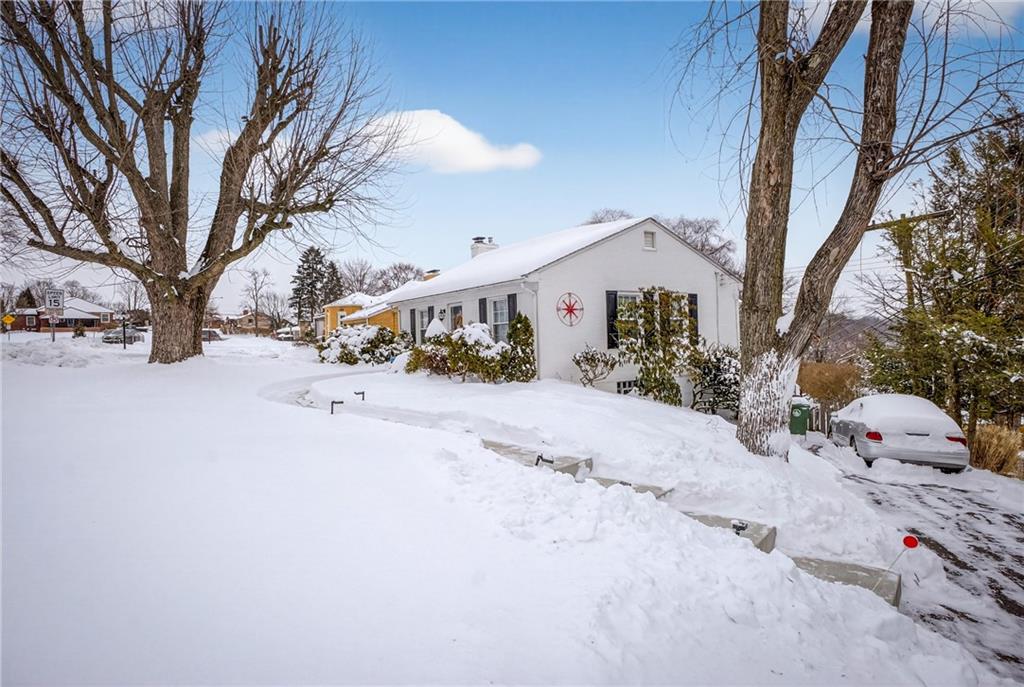 4241 Greenridge Road Pittsburgh, PA 15234 - Photo 5 of 50 a view of a white house with a snow in a yard