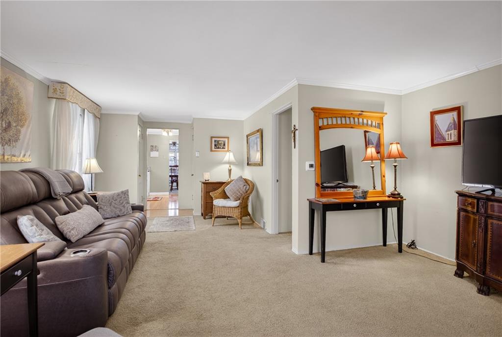 4241 Greenridge Road Pittsburgh, PA 15234 - Photo 8 of 50 a living room with furniture a flat screen tv and a refrigerator