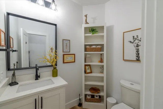 a kitchen with a table chairs sink and cabinets