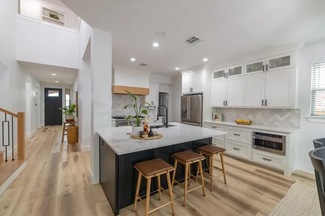 a kitchen with refrigerator and cabinets