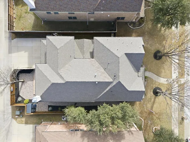 a aerial view of a house with a yard and potted plants