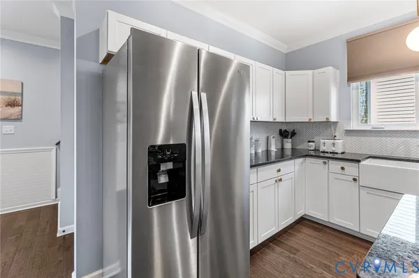 a kitchen with stainless steel appliances granite countertop a refrigerator and a stove top oven