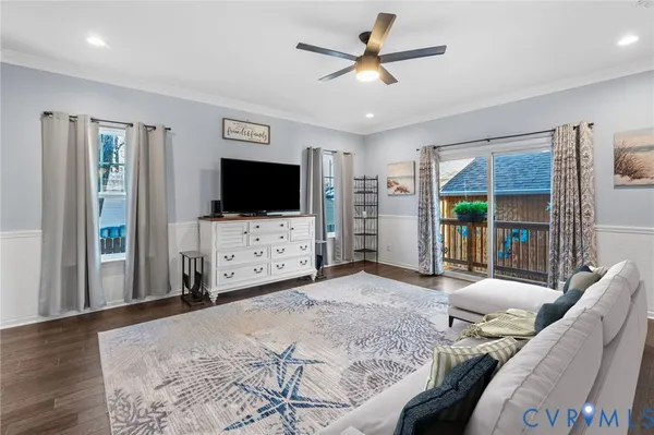 a bedroom with furniture and a flat screen tv