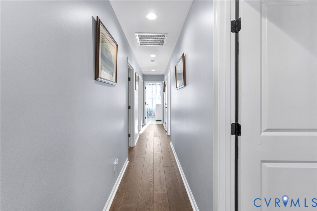123 8th Street Colonial Beach, VA 22443 - Photo 17 of 36 a view of a hallway with wooden floor and staircase