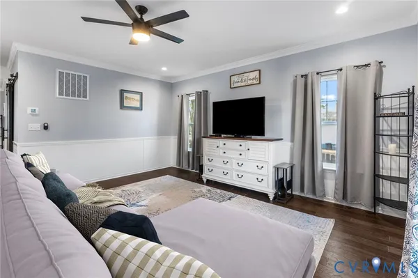 a bedroom with furniture and flat screen tv