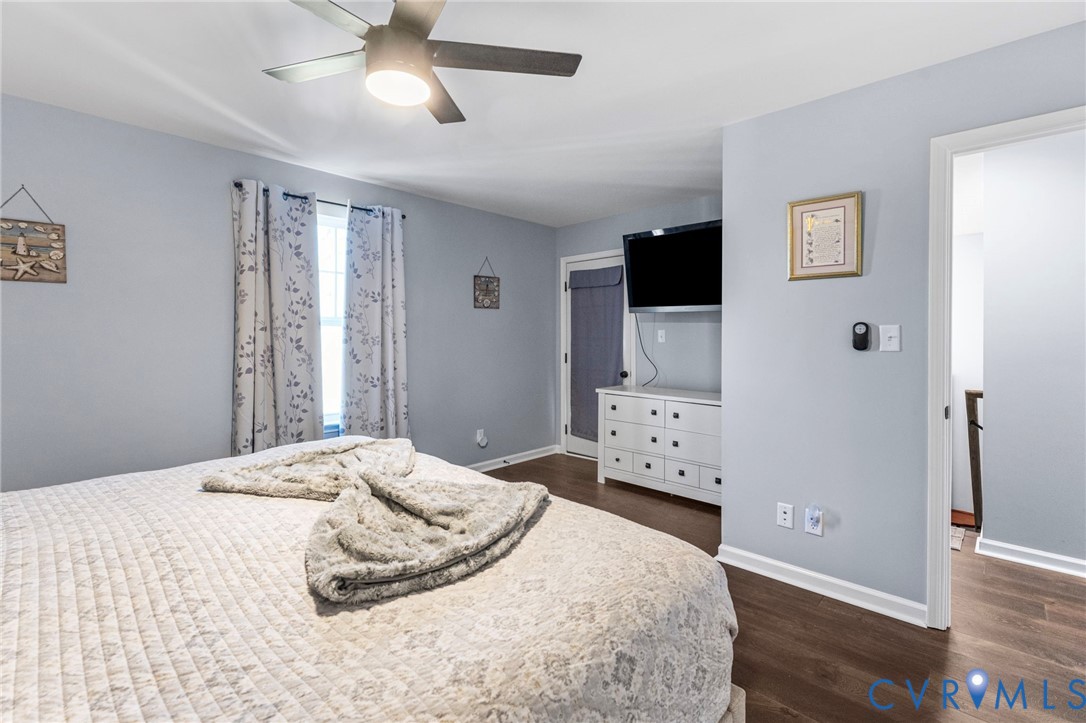 123 8th Street Colonial Beach, VA 22443 - Photo 19 of 36 a bedroom with a bed and a flat screen tv