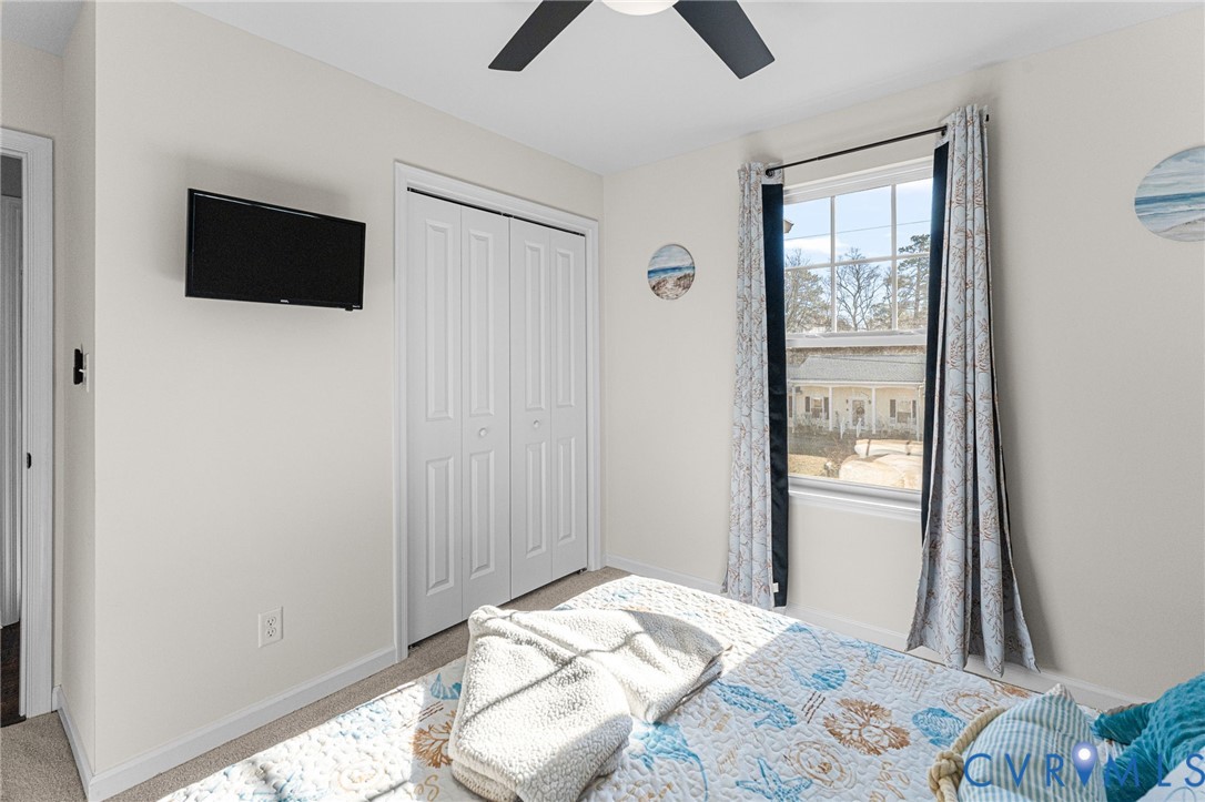 123 8th Street Colonial Beach, VA 22443 - Photo 27 of 36 a bedroom with a bed and a flat screen tv