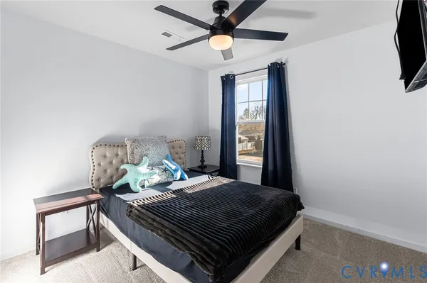 a bedroom with a bed and a flat tv screen