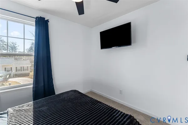 a view of a livingroom with a flat tv screen and a floor to ceiling window