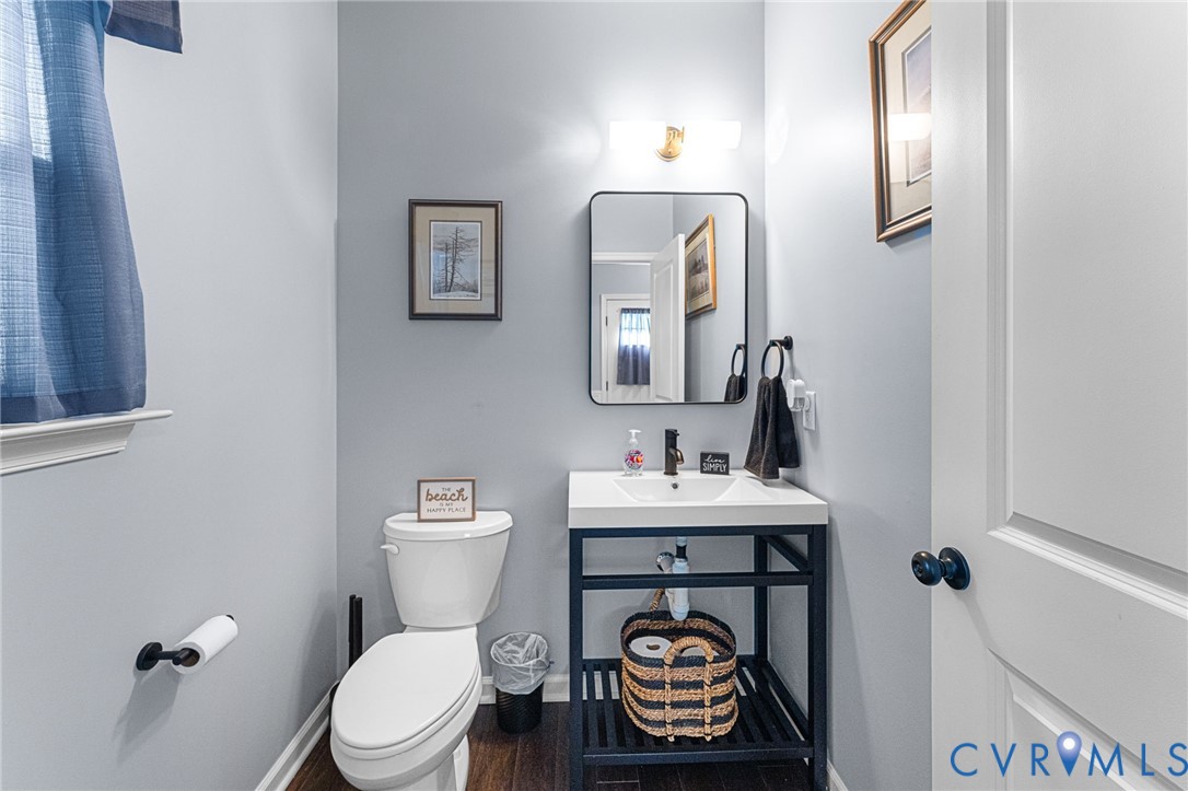 123 8th Street Colonial Beach, VA 22443 - Photo 5 of 36 a bathroom with a toilet a sink and mirror