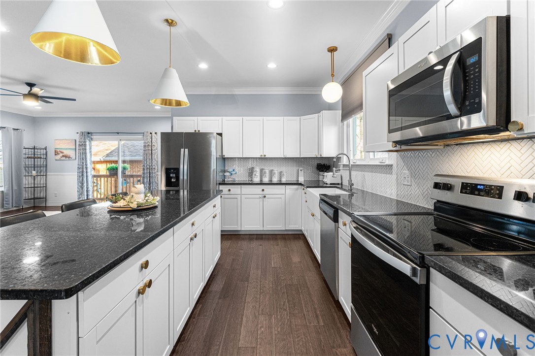 123 8th Street Colonial Beach, VA 22443 - Photo 7 of 36 a large kitchen with stainless steel appliances granite countertop a sink a stove and cabinets