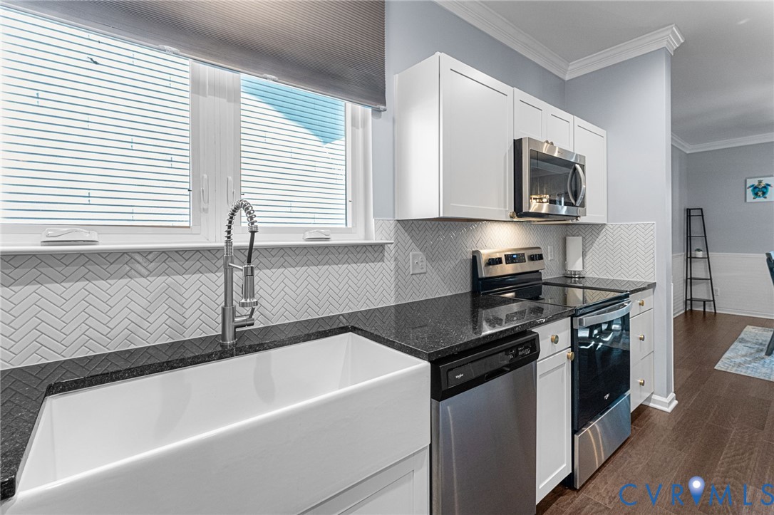 123 8th Street Colonial Beach, VA 22443 - Photo 9 of 36 a kitchen with stainless steel appliances granite countertop a sink stove and microwave