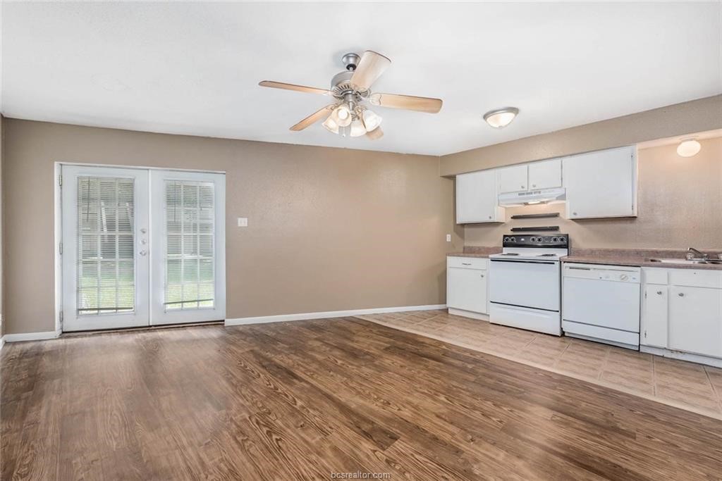 3900 Old College Road, Unit 10 Bryan, TX 77801 - Photo 2 of 12 a view of a kitchen with wooden floor and stainless steel appliances