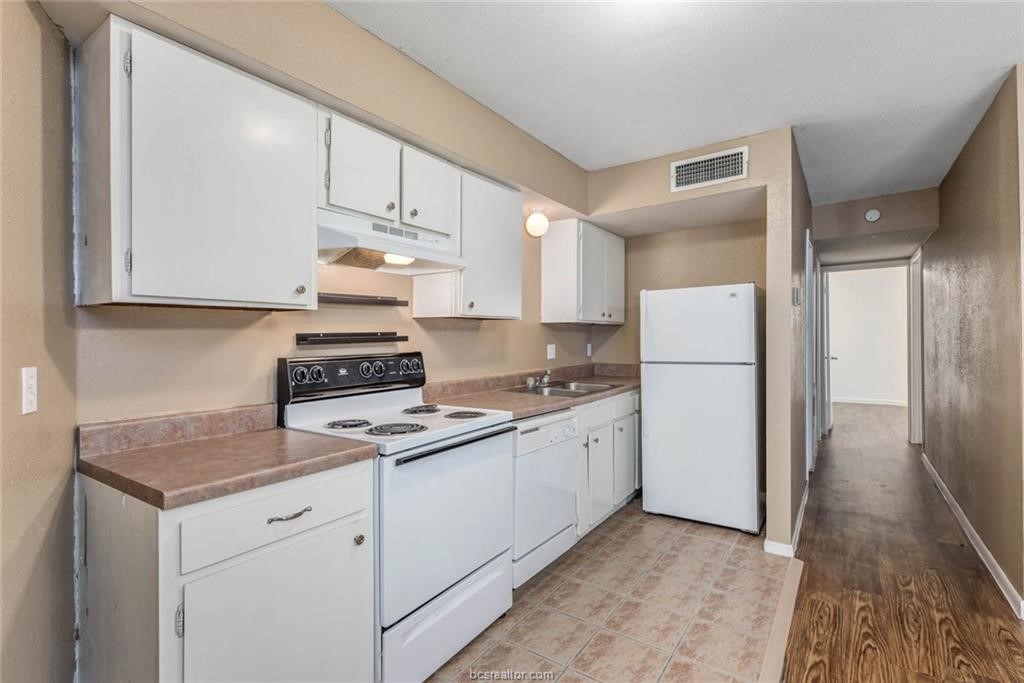 3900 Old College Road, Unit 10 Bryan, TX 77801 - Photo 4 of 12 a kitchen with appliances a sink and cabinets