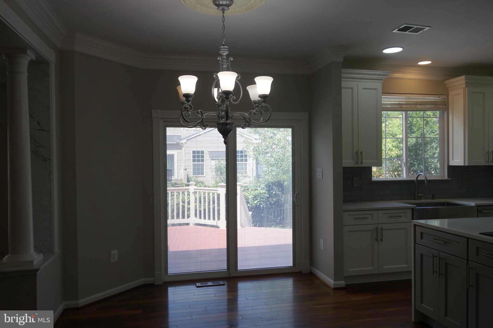 8196 Tenbrook Drive Gainesville, VA 20155 - Photo 13 of 51 a view of a kitchen with a sink wooden floor and a window