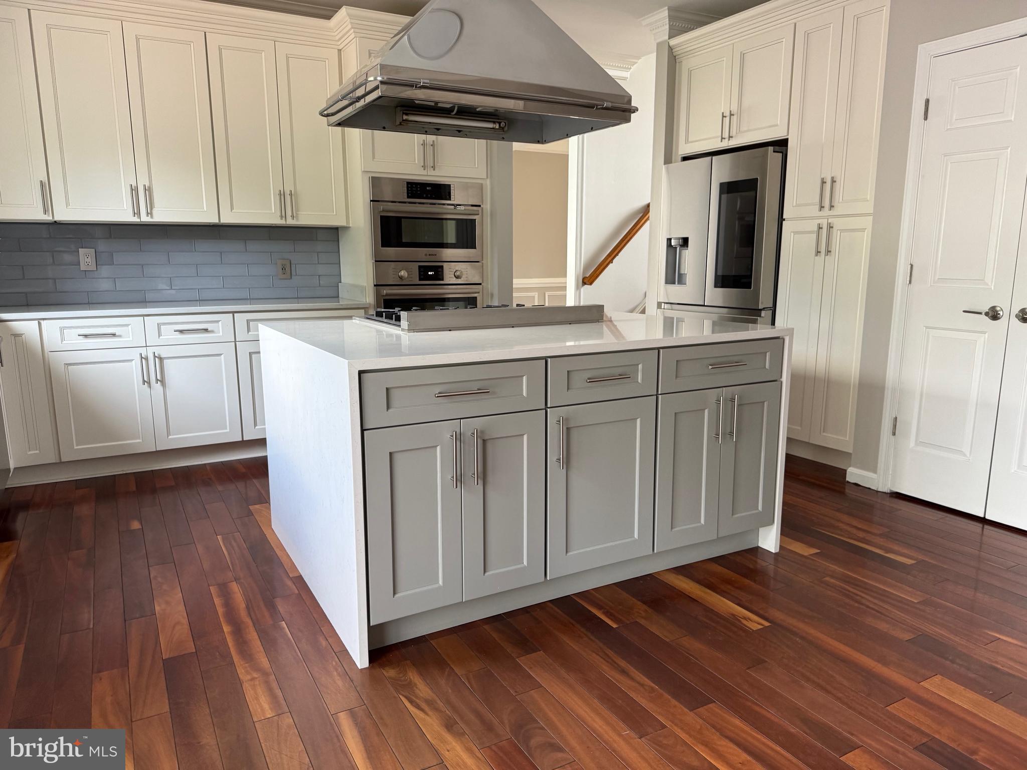 8196 Tenbrook Drive Gainesville, VA 20155 - Photo 14 of 51 a kitchen with stainless steel appliances granite countertop a sink a stove a microwave and cabinets