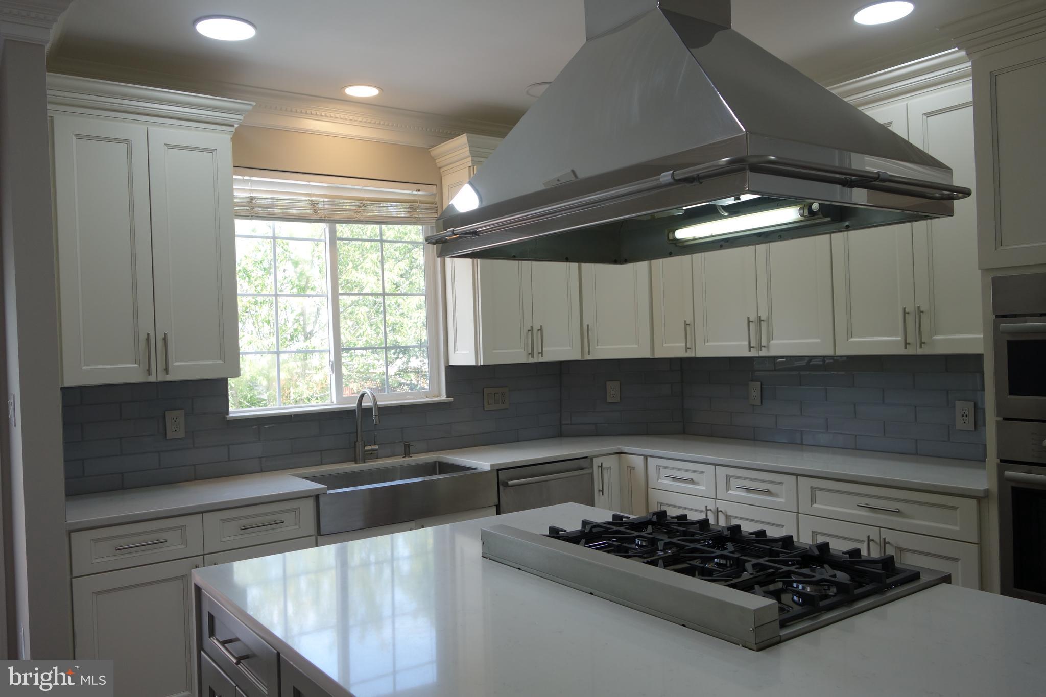 8196 Tenbrook Drive Gainesville, VA 20155 - Photo 15 of 51 a kitchen with a stove a sink and a refrigerator