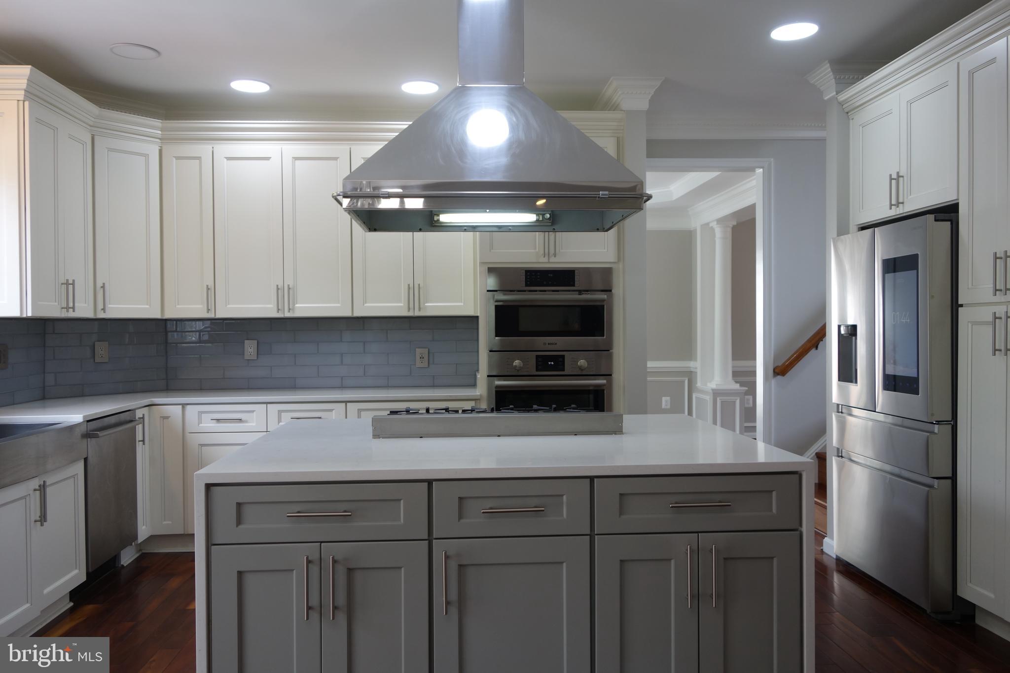 8196 Tenbrook Drive Gainesville, VA 20155 - Photo 17 of 51 a kitchen with stainless steel appliances granite countertop a refrigerator and a stove top oven