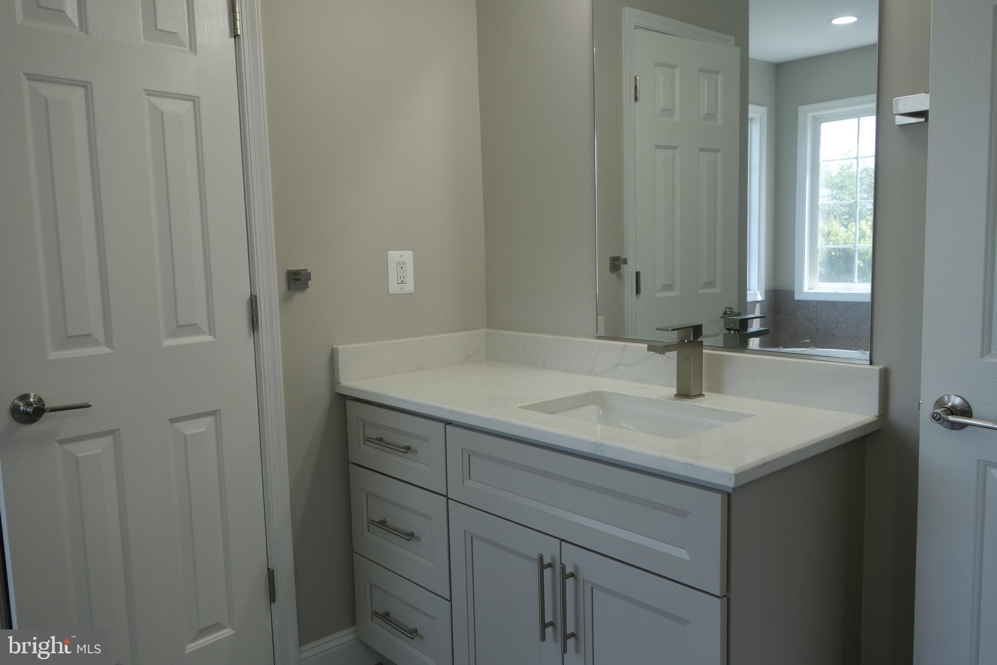 8196 Tenbrook Drive Gainesville, VA 20155 - Photo 29 of 51 a bathroom with a granite countertop sink and a mirror
