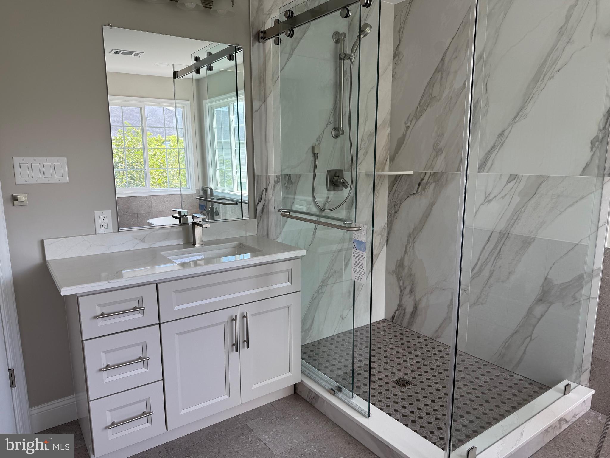 8196 Tenbrook Drive Gainesville, VA 20155 - Photo 30 of 51 a bathroom with a shower sink and mirror