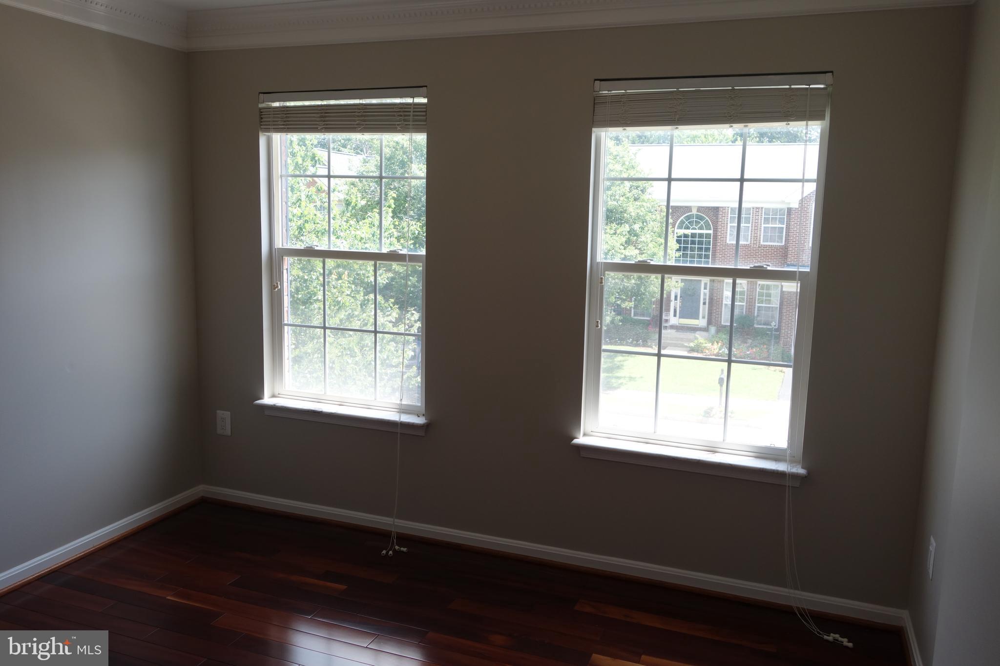 8196 Tenbrook Drive Gainesville, VA 20155 - Photo 36 of 51 a view of an empty room with wooden floor and a window