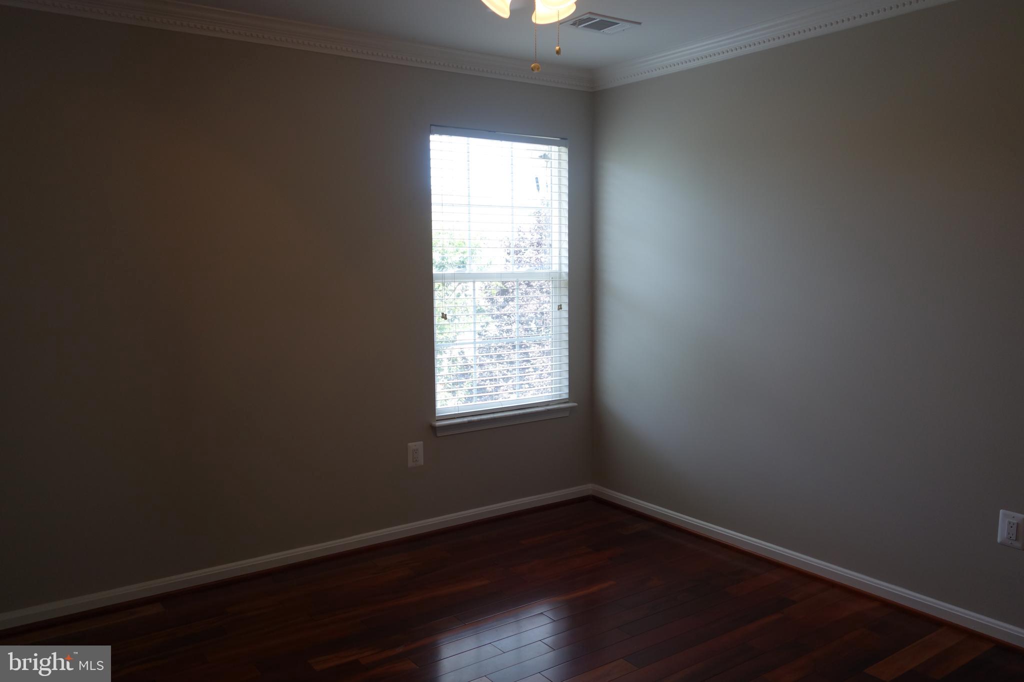 8196 Tenbrook Drive Gainesville, VA 20155 - Photo 37 of 51 an empty room with wooden floor and windows