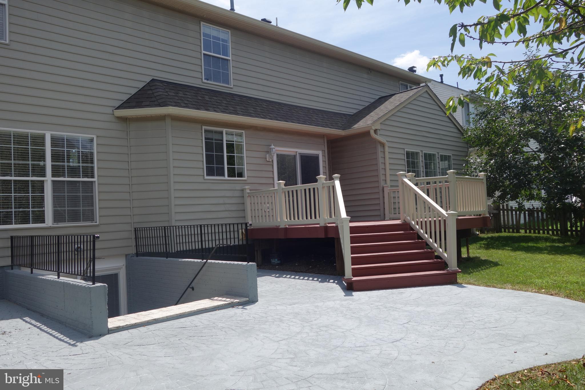 8196 Tenbrook Drive Gainesville, VA 20155 - Photo 49 of 51 a view of a house with a yard and stairs