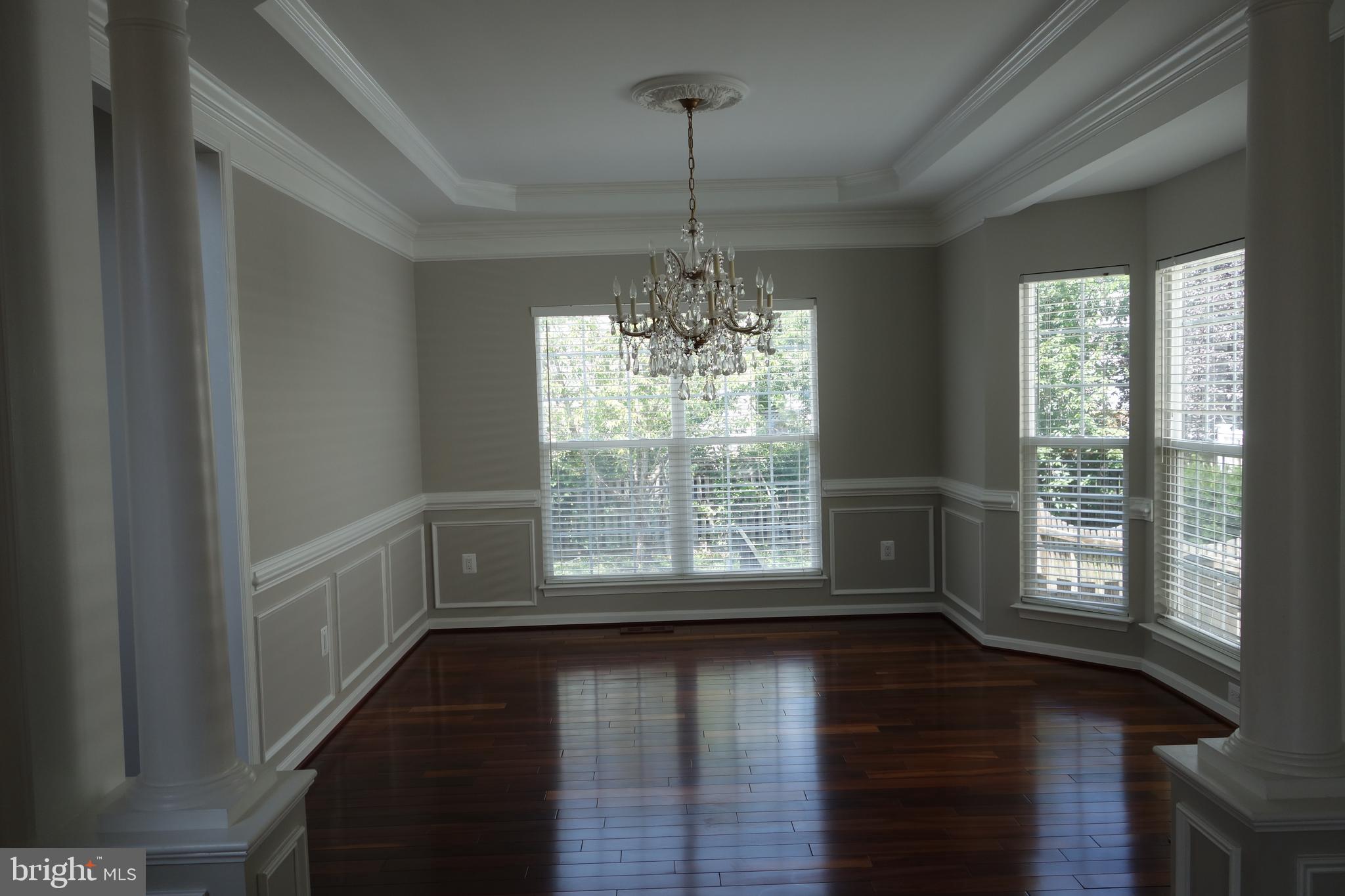 8196 Tenbrook Drive Gainesville, VA 20155 - Photo 8 of 51 a view of an empty room with wooden floor and a window