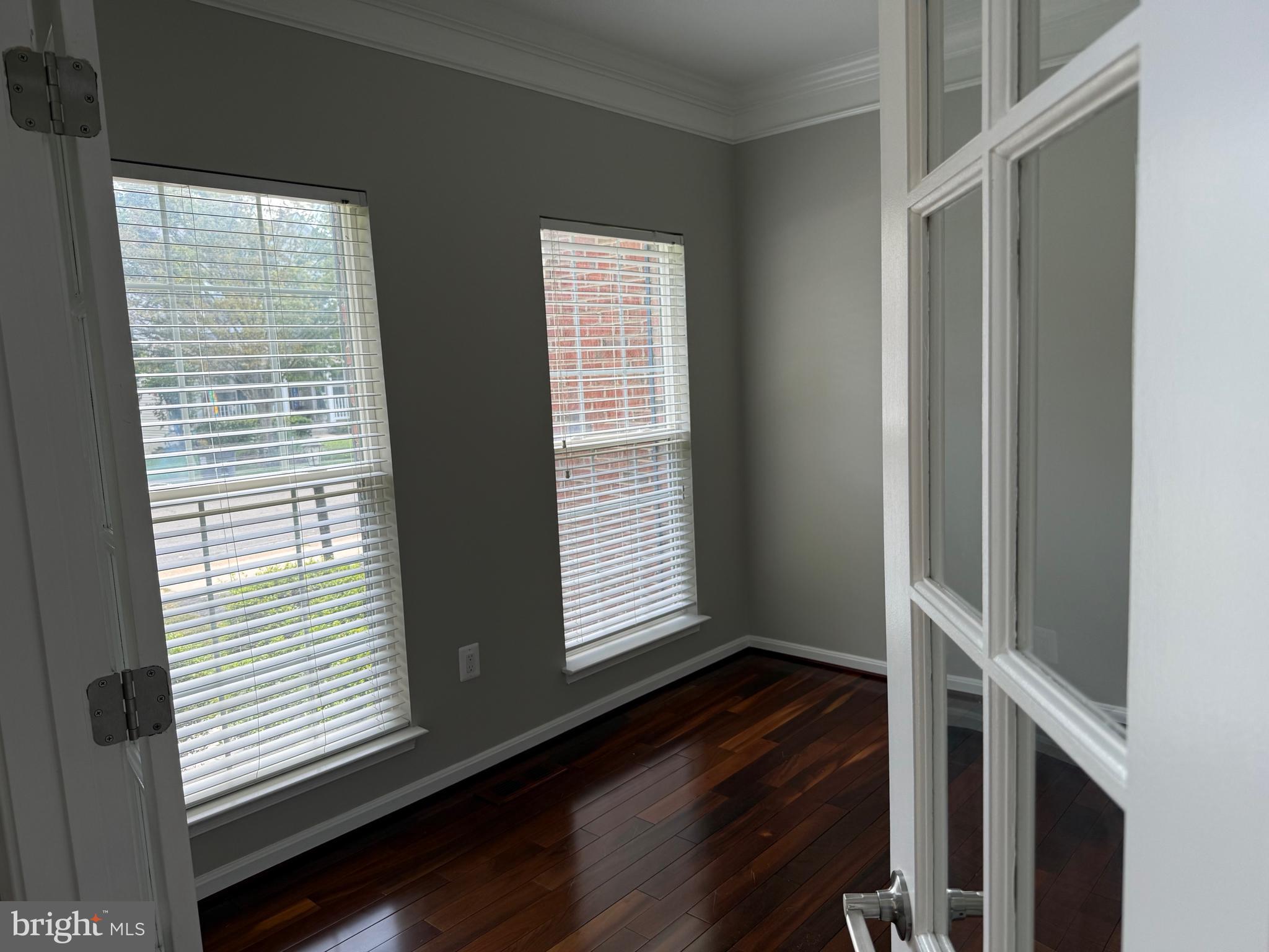 8196 Tenbrook Drive Gainesville, VA 20155 - Photo 10 of 51 a view of an empty room with wooden floor and a window