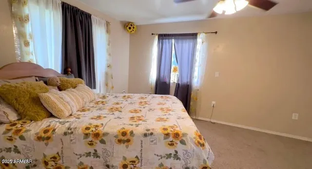 a bedroom with a bed and a window