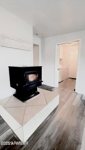 a living room with hard wood floors and a fireplace