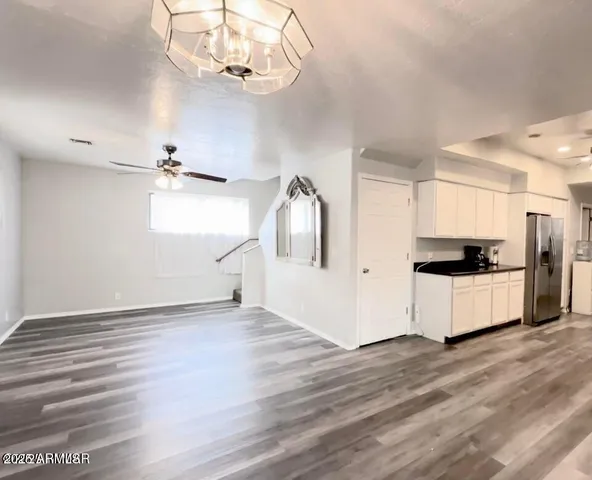 a view of a kitchen with a sink and dishwasher a kitchen island with wooden floor