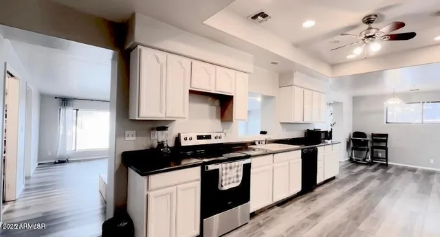 a kitchen with stainless steel appliances a stove sink and cabinets