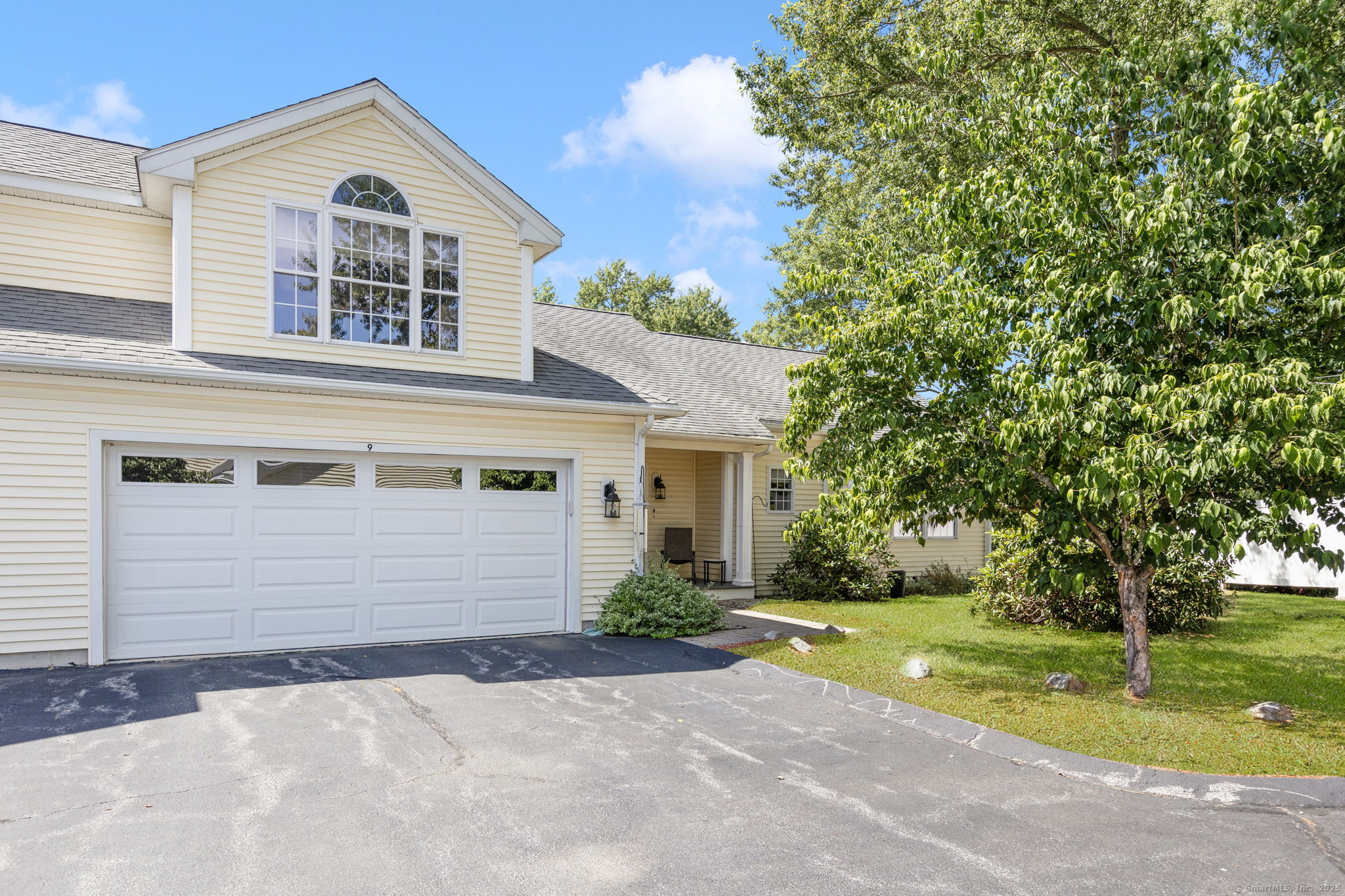 a front view of house with yard and green space