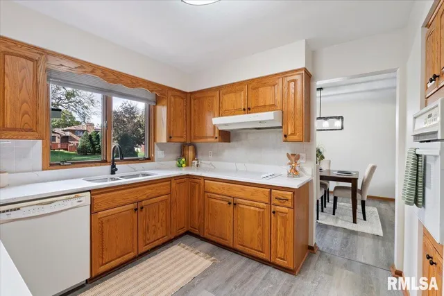 a kitchen with stainless steel appliances a refrigerator and a stove top oven
