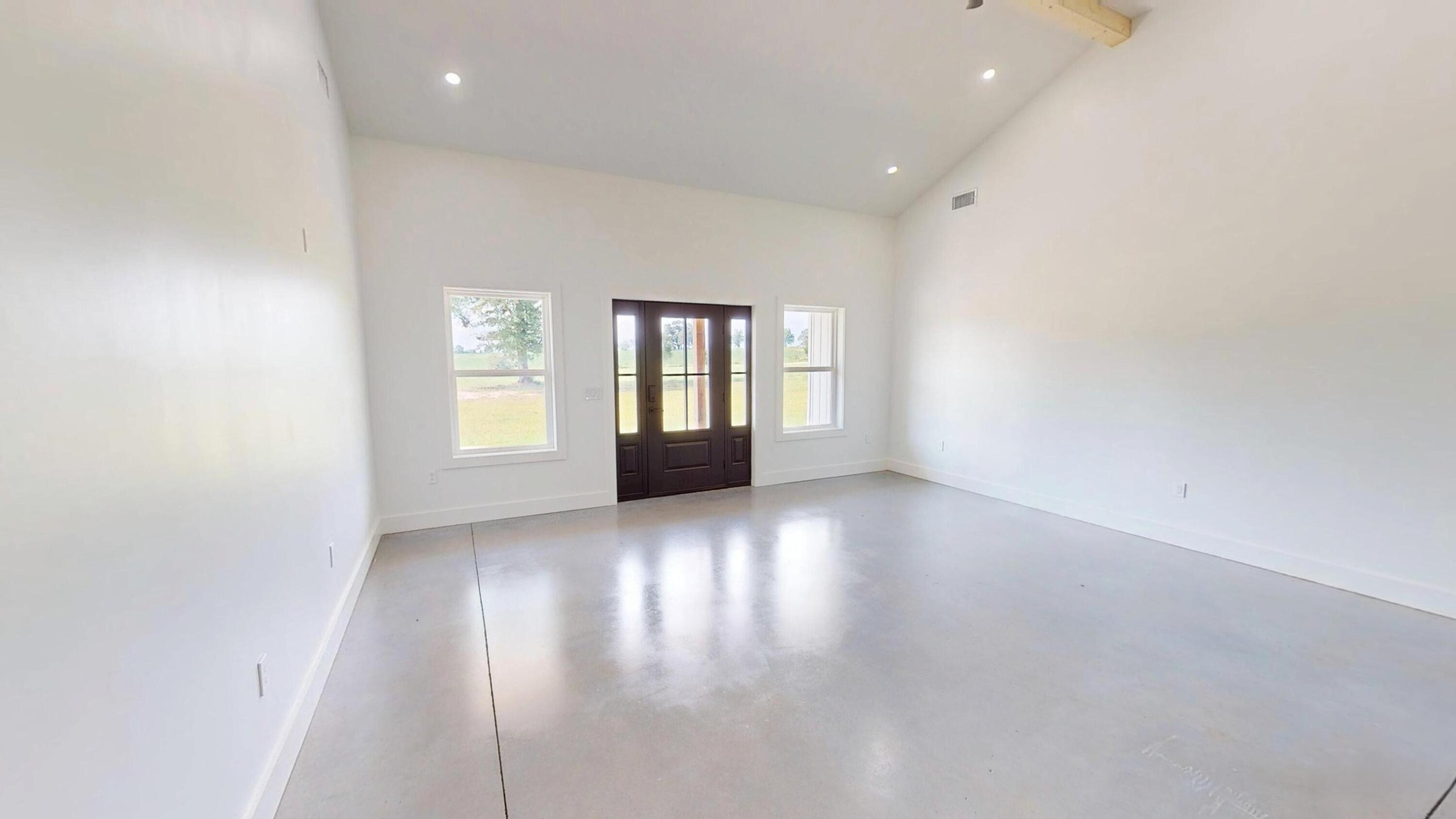 37837 Straughn School Road Andalusia, AL 36421 - Photo 12 of 30 an empty room with wooden floor and windows