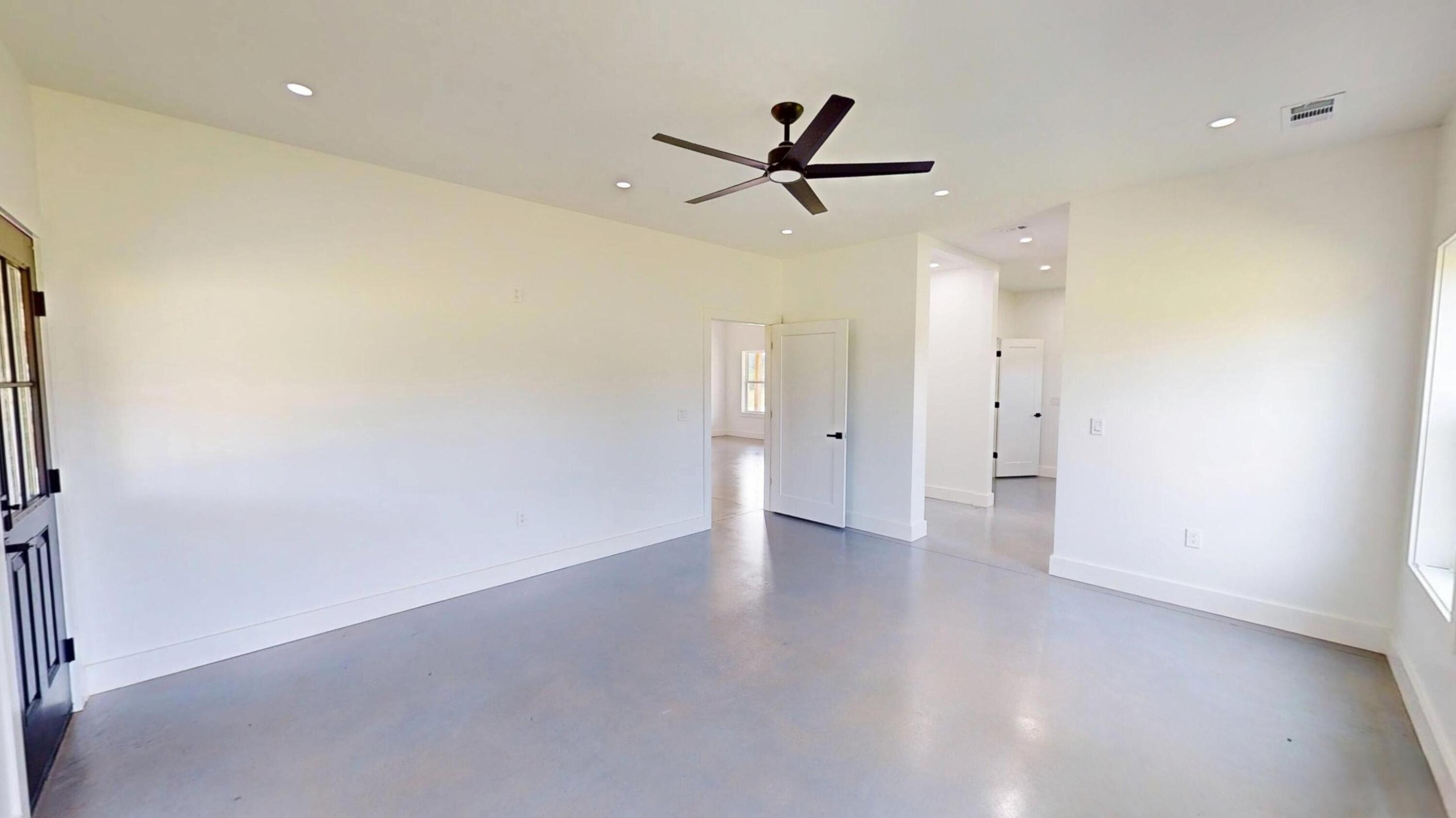 37837 Straughn School Road Andalusia, AL 36421 - Photo 17 of 30 an empty room with wooden floor and windows