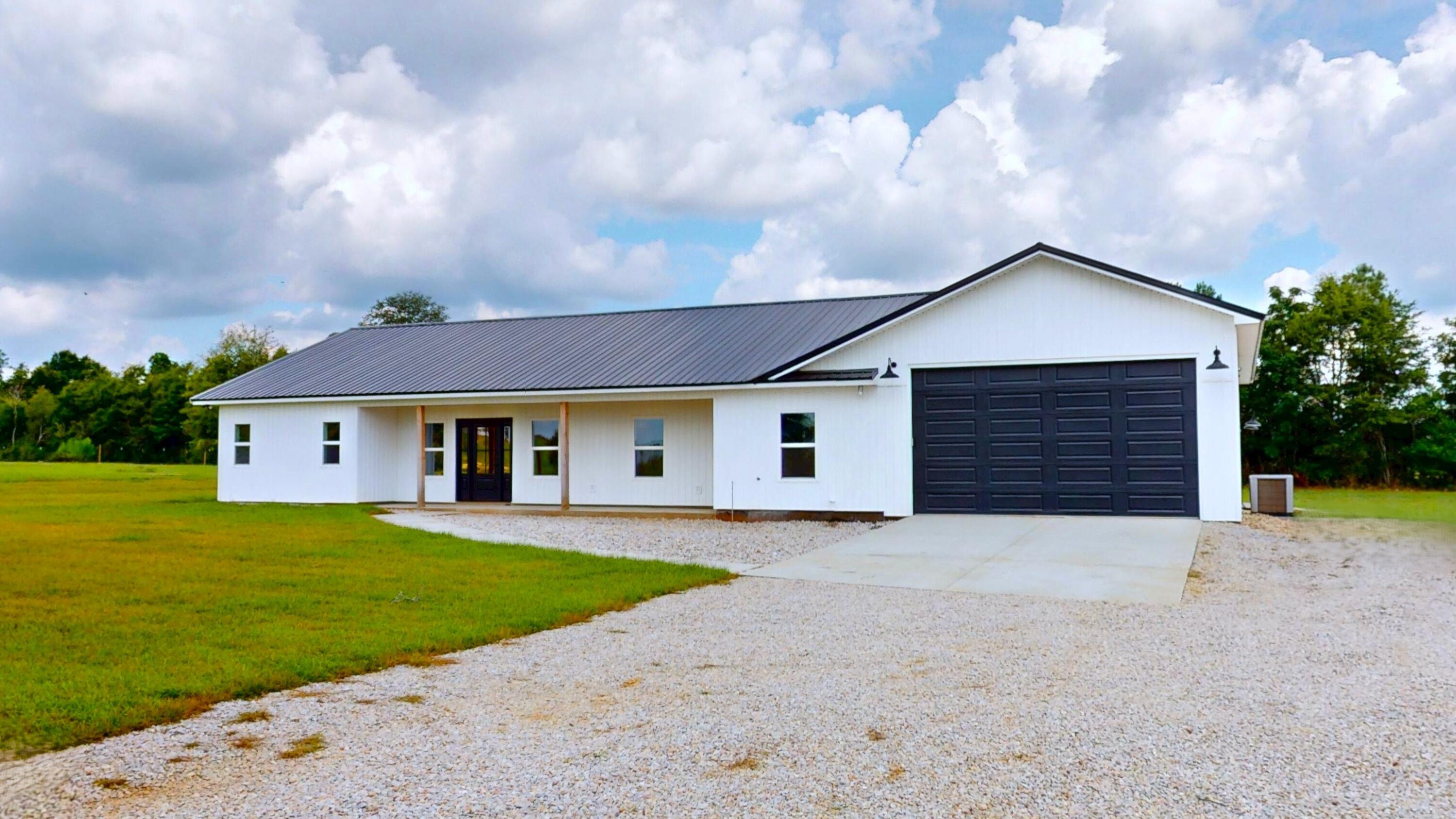 37837 Straughn School Road Andalusia, AL 36421 - Photo 26 of 30 a front view of a house with a yard and garage
