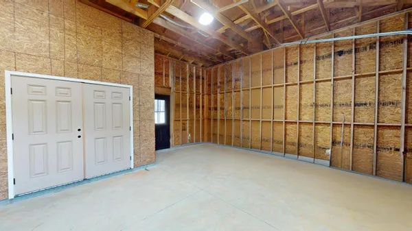 a view of an empty room with wooden walls