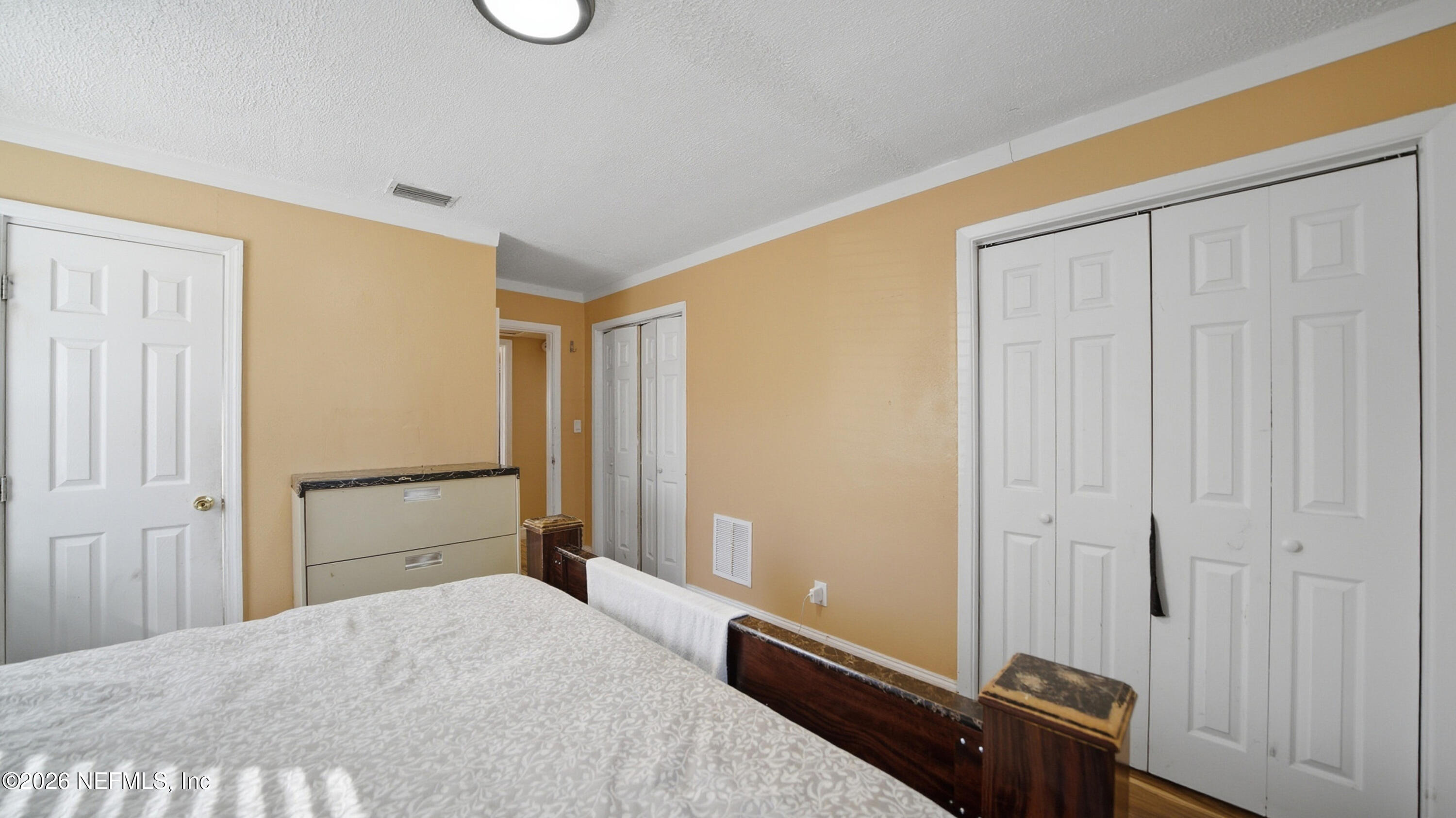 2238 Ligustrum Road Jacksonville, FL 32211 - Photo 16 of 31 a bedroom with a bed and wooden floor
