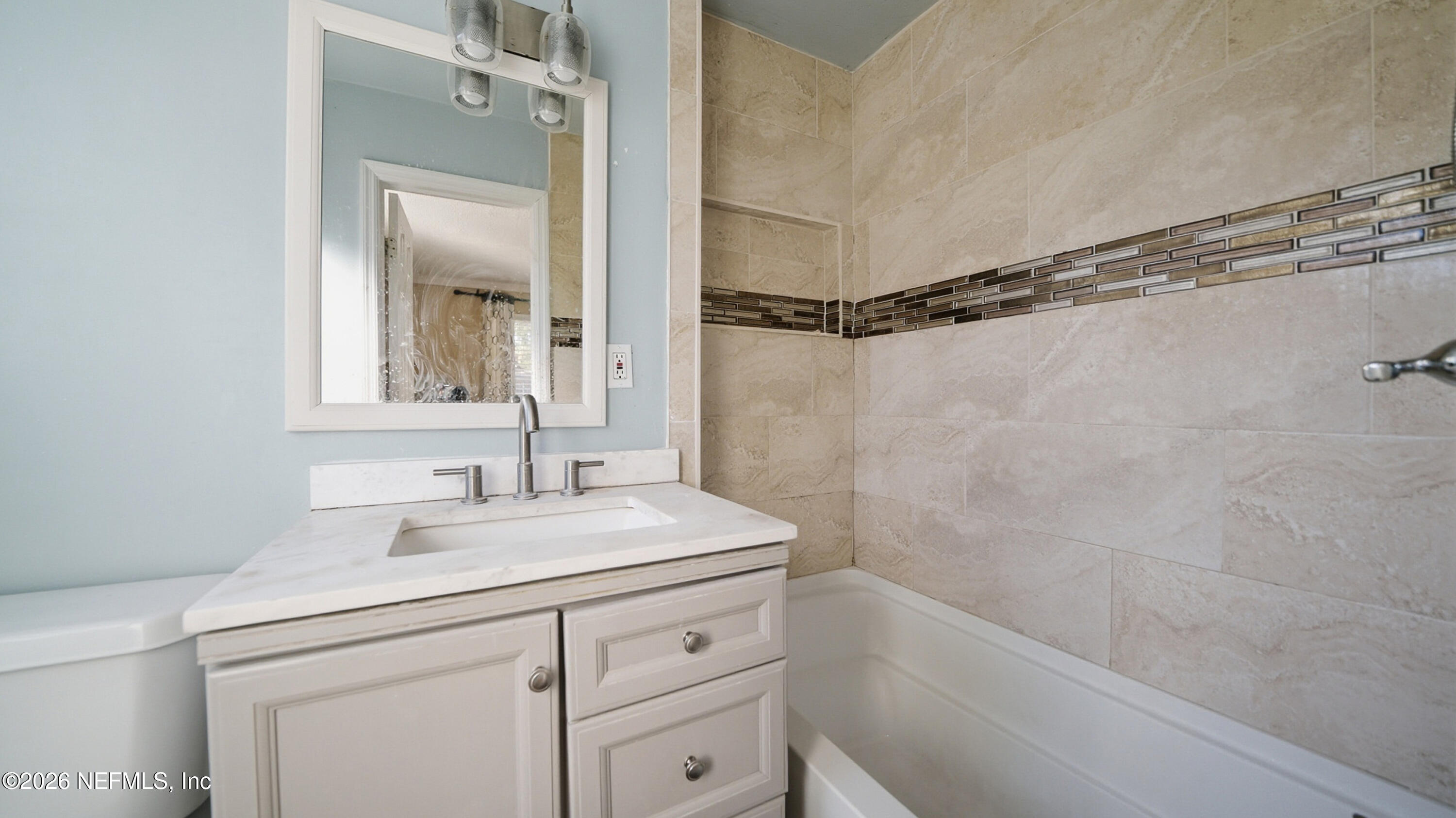 2238 Ligustrum Road Jacksonville, FL 32211 - Photo 18 of 31 a bathroom with a sink a vanity and a mirror