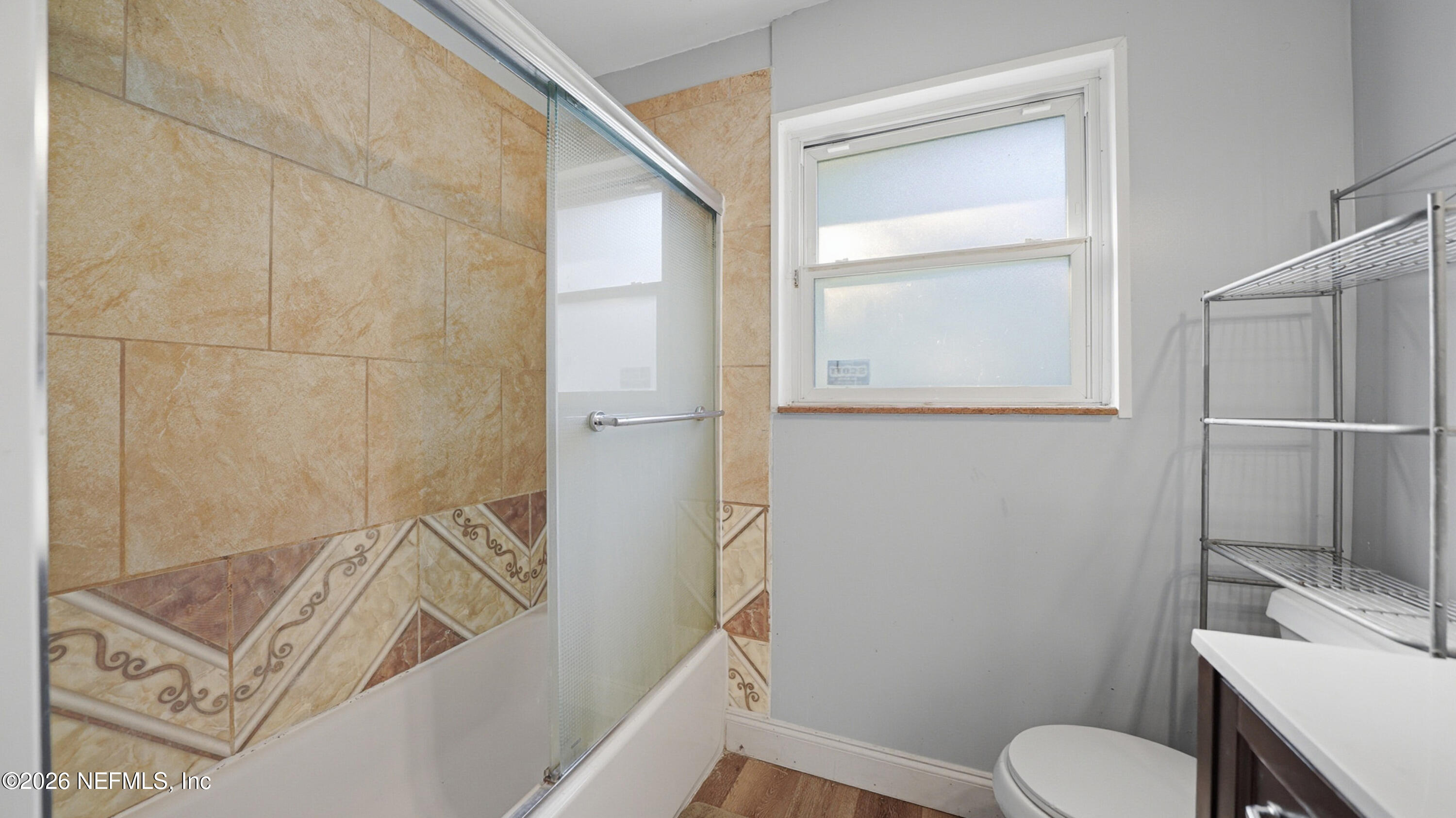 2238 Ligustrum Road Jacksonville, FL 32211 - Photo 22 of 31 a bathroom with a granite countertop sink toilet and shower