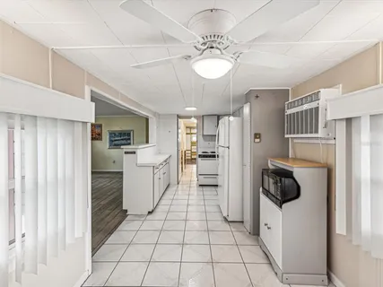a kitchen with white cabinets and white appliances